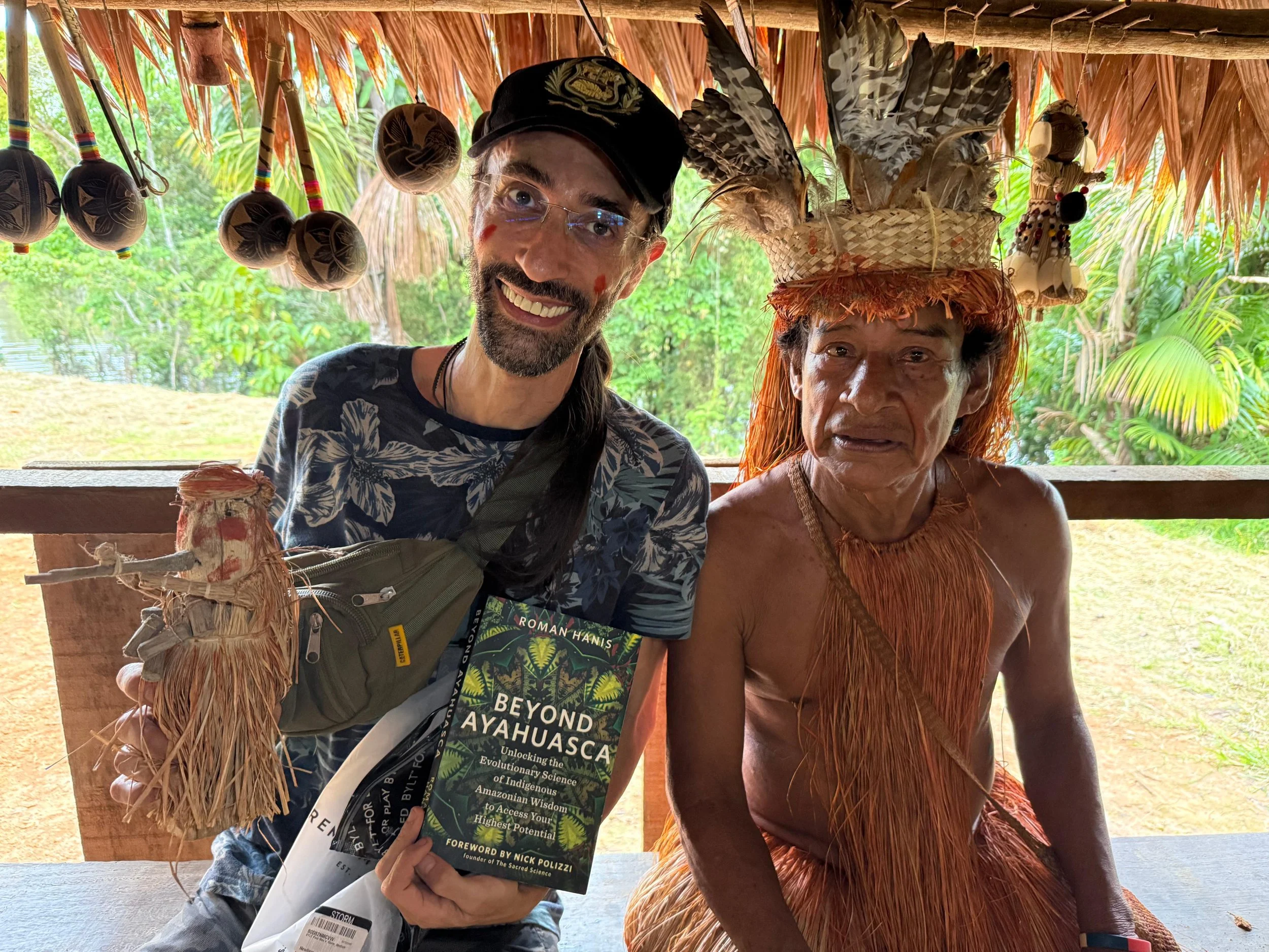 Roman Hanis and Ancelmo holding a copy of Beyond Ayahuasca